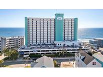 Oceanfront high-rise building with parking and surrounding buildings at 1210 N Waccamaw Dr. # 404, Garden City Beach, SC 29576