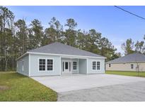 Newly built light blue house with a large concrete patio and driveway at 5575 Dinkler Ave., Loris, SC 29569