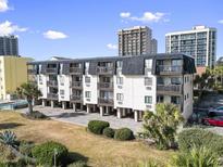Oceanfront building, three-story, with parking underneath and grassy area at 201 76Th Ave. N # D-1, Myrtle Beach, SC 29572