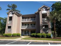 Attractive two-story building with balconies and landscaping at 598 Blue Stem Dr. # 52D, Pawleys Island, SC 29585