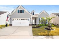 Gray house with white garage door and landscaping at 6550 Anterselva Dr., Myrtle Beach, SC 29572