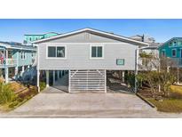 Elevated beach house exterior, gray siding, spacious deck at 431 28Th St. S, Sunset Beach, NC 28468