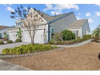 Two-story house with attached garage and landscaped yard at 4463 Livorn Loop # 4463, Myrtle Beach, SC 29579