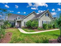 Curb appeal abounds in this charming one-story home featuring a landscaped lawn and walkway at 8605 Hopper Ct., Myrtle Beach, SC 29579