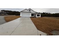 White house with a two-car garage and a long concrete driveway at Tbb 20 Privetts Rd., Conway, SC 29526