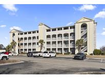Three-story building with parking and landscaping at 4519 N Plantation Dr. # X-9, Little River, SC 29566