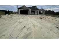 Newly constructed home with a two-car garage and spacious front yard at Tbd 16 Mineral Springs Rd., Conway, SC 29527