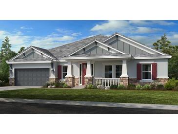 Craftsman style home with gray siding, red shutters, and stone accents at 1341 Arklow Cir, Ormond Beach, FL 32174