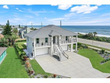 Oceanfront home with a metal roof and two-car garage at 31 Seabridge Dr, Ormond Beach, FL 32176