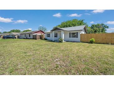 Cute bungalow-style home with a grassy yard and wooden fence at 139 Prospect Ave, Winter Haven, FL 33880