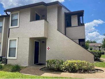 Two-story condo building with private entrance and landscaping at 2923 Antique Oaks Cir # 37, Winter Park, FL 32792