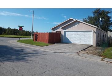 House exterior with attached garage and wooden fence at 5345 Timberleaf Blvd, Orlando, FL 32811