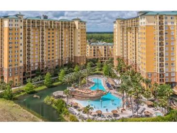 Luxury resort with multiple buildings, pools, and water features at 8101 Resort Village Dr # 3303, Orlando, FL 32821