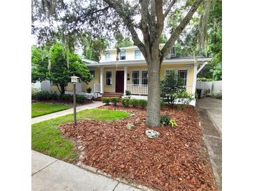 Charming yellow house with mature landscaping at 495 S Orange Ave, Bartow, FL 33830