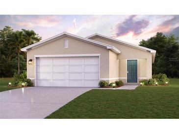 Two-car garage and front yard landscaping at 1021 Ambleside Dr, Haines City, FL 33844