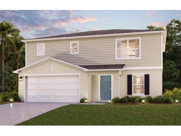 Two-story house with beige siding, two-car garage, and teal door at 1229 Chester Ave, Haines City, FL 33844