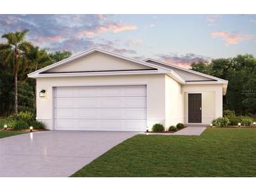 Two-car garage and front yard landscaping at 2211 Majestic Span Ave, Eagle Lake, FL 33839