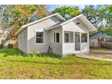 Charming bungalow exterior with a covered porch and well-maintained lawn at 4251 Tangerine Ave, Sanford, FL 32773