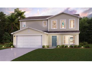 Two-story house with a large garage and well-manicured lawn at 1705 Seabass Ln, Poinciana, FL 34759