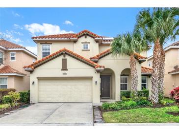 Two-story house with tile roof, attached garage, and landscaped yard at 5240 Oakbourne Ave, Davenport, FL 33837