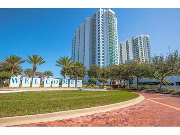 Luxury high rise building with palm trees and landscaping at 231 Riverside Dr # 1904, Daytona Beach, FL 32117