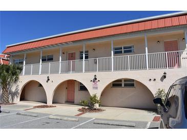 Two-story building with terracotta roof, balconies, and arched entryways at 1510 Ocean Shore Blvd # 4140, Ormond Beach, FL 32176