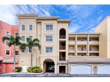 Building exterior with parking and palm trees at 424 Luna Bella Ln # 222, New Smyrna Beach, FL 32168