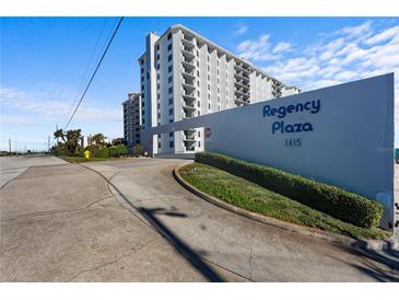 Regency Plaza, 1415: Building exterior view with landscaping and signage at 1415 Ocean Shore Blvd # B030, Ormond Beach, FL 32176