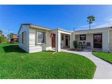 Inviting beachfront home with a well-manicured lawn and walkway at 196 Cardinal Dr # A, Ormond Beach, FL 32176