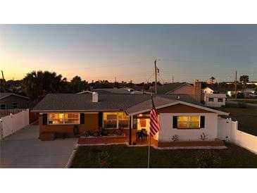 Charming single-Gathering home with a fenced yard and American flag at 21 Sunset Blvd, Ormond Beach, FL 32176