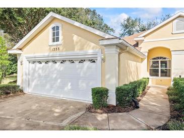 House exterior featuring a two-car garage and well-manicured landscaping at 1333 Asher Ct # 1333, Ormond Beach, FL 32174