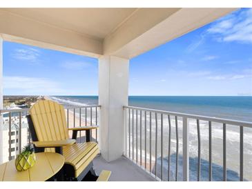 Breathtaking ocean view from a condo balcony, yellow adirondack chairs at 89 S Atlantic Ave # 1401, Ormond Beach, FL 32176