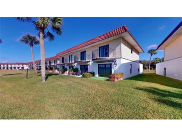 Ground level condo unit with private patio, water views, and lush landscaping at 11 Ocean Palm Villa S # 11, Flagler Beach, FL 32136