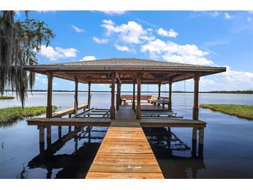 Lakefront property with a boathouse and dock at 1261 W Lakeshore Dr, Clermont, FL 34711