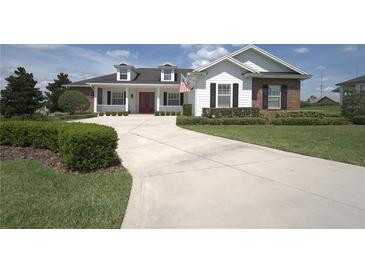 Two-story home with brick and white siding at 6514 Crews Lake Crest Loop, Lakeland, FL 33813