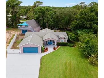 Aerial view of a two-story house with a detached garage at 12270 Virginia Dr, Leesburg, FL 34788