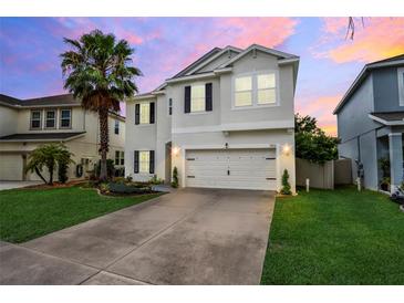 Two-story house with a white exterior and landscaped yard at 1103 White Water Bay Dr, Groveland, FL 34736