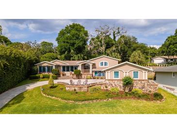 Beautiful home with landscaping and stone accents at 2537 E Crooked Lake Dr, Eustis, FL 32726