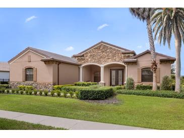 Exterior of a single-story house with stone accents at 25499 Hawks Run Ln, Sorrento, FL 32776