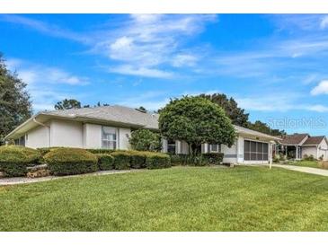 Single-story home with well-maintained lawn at 6435 Borg St, Leesburg, FL 34748