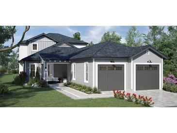 Two-story home with gray siding, two-car garage, and landscaping at 576 Casey Loop, Mount Dora, FL 32757