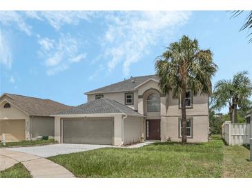 Two story house with gray roof, attached garage, and palm tree at 15847 Wilkinson Dr, Clermont, FL 34714