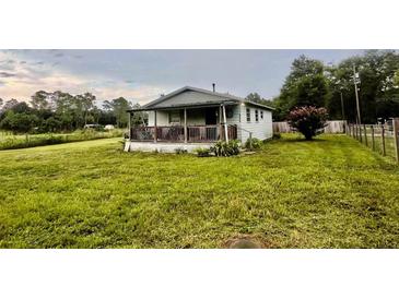 Cute ranch home with a spacious front yard and covered porch at 708 Lake Shore Dr, Pierson, FL 32180