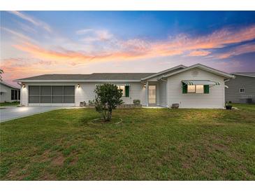 Single-story house with white siding and carport at 9823 Se 178Th Ln, Summerfield, FL 34491