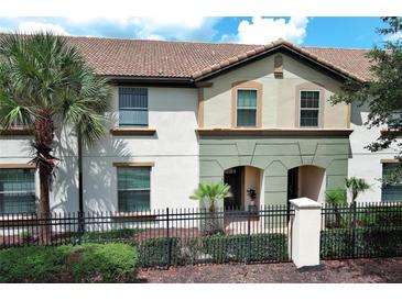 Two-story townhome with a Spanish-style roof and a well-maintained front yard at 2019 Majorca Dr, Kissimmee, FL 34747