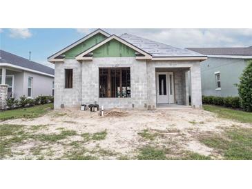 New construction home with block exterior and a modern design at 10619 Grand Oaks Blvd, Oxford, FL 34484