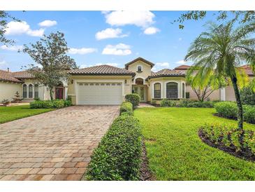 Single-story home with tile roof, paver driveway, and landscaped lawn at 9323 San Jose Blvd, Howey In The Hills, FL 34737