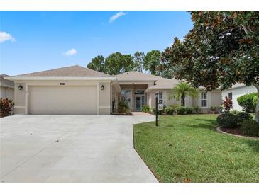 Beautiful single-Gathering home with a two-car garage and lush landscaping at 24215 Belle Mede Dr, Leesburg, FL 34748