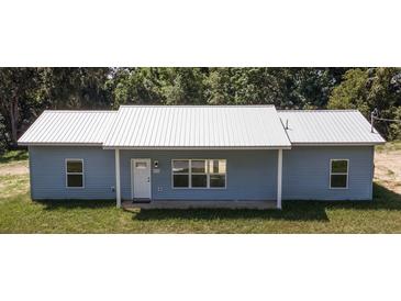 Newly constructed home with metal roof and light blue siding at 6936 Se 124Th Ln, Belleview, FL 34420