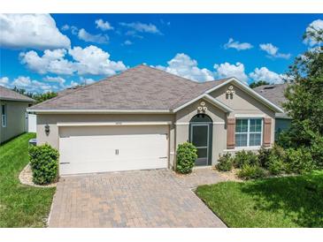 One-story home with attached garage and landscaping at 3450 Landing Vw, Tavares, FL 32778